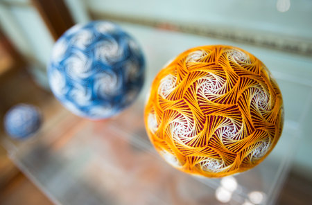 Temari balls are a folk art form that originated in China and was introduced to Japan around the 7th century A.D. "Temari" means "hand ball" in Japanese. Embroidered balls may be used in handball games.のeditorial素材