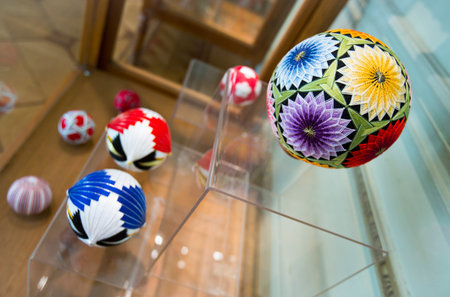 Temari balls are a folk art form that originated in China and was introduced to Japan around the 7th century A.D. "Temari" means "hand ball" in Japanese. Embroidered balls may be used in handball games.のeditorial素材