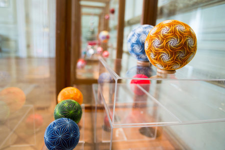 Temari balls are a folk art form that originated in China and was introduced to Japan around the 7th century A.D. "Temari" means "hand ball" in Japanese. Embroidered balls may be used in handball games.のeditorial素材