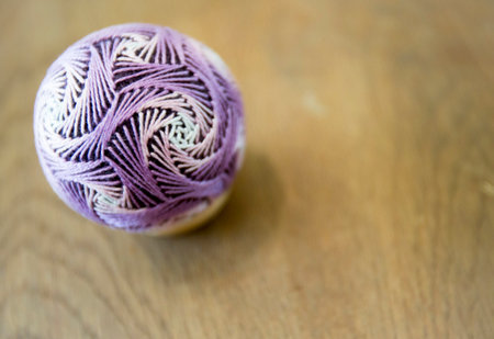 Temari balls are a folk art form that originated in China and was introduced to Japan around the 7th century A.D. "Temari" means "hand ball" in Japanese. Embroidered balls may be used in handball games.のeditorial素材