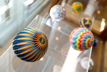 Temari balls are a folk art form that originated in China and was introduced to Japan around the 7th century A.D. "Temari" means "hand ball" in Japanese. Embroidered balls may be used in handball games.のeditorial素材