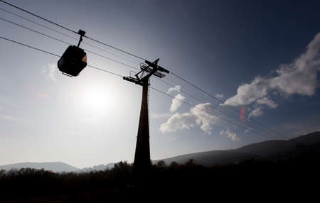 Silhouetee of a ski cabin lift in the mountain.の写真素材