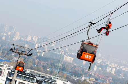 Sofia, Bulgaria - November 6, 2014: Rescuers from Mountain Rescue Service at Bulgarian Red Cross are participating in a training cource which took place at Vitosha mountain near Sofia. The course utilizes techniques for rescuing people from a cabin of a sのeditorial素材