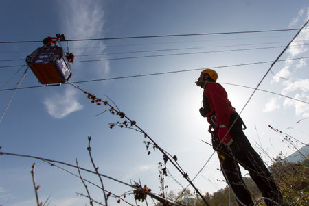 Sofia, Bulgaria - November 6, 2014: Rescuers from Mountain Rescue Service at Bulgarian Red Cross are participating in a training cource which took place at Vitosha mountain near Sofia. The course utilizes techniques for rescuing people from a cabin of a sのeditorial素材