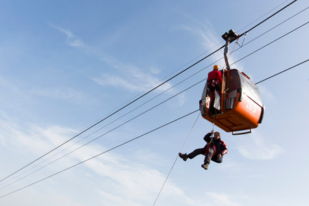 Sofia, Bulgaria - November 6, 2014: Rescuers from Mountain Rescue Service at Bulgarian Red Cross are participating in a training cource which took place at Vitosha mountain near Sofia. The course utilizes techniques for rescuing people from a cabin of a sのeditorial素材