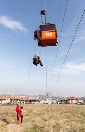 Sofia, Bulgaria - November 6, 2014: Rescuers from Mountain Rescue Service at Bulgarian Red Cross are participating in a training cource which took place at Vitosha mountain near Sofia. The course utilizes techniques for rescuing people from a cabin of a sのeditorial素材