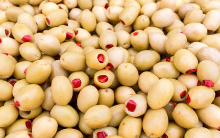 Green olives with red pepper prepared for selling at a Turkish market street.の写真素材