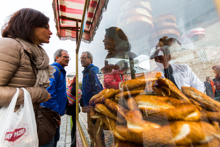 Istanbul, Turkey - November 14, 2014: Tourists are buying pretzels in the center of Istanbul.のeditorial素材