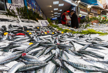 Istanbul, Turkey - November 15, 2014: Sellers are offering Horse Mackerel fish to the tourists at a Turkish market street.のeditorial素材