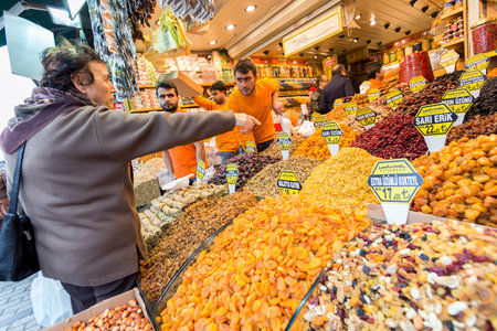 Istanbul, Turkey - November 15, 2014: Sellers are offering products to the tourists at a bazaar of nuts, delight and sweets in Istanbul, Turkeyのeditorial素材