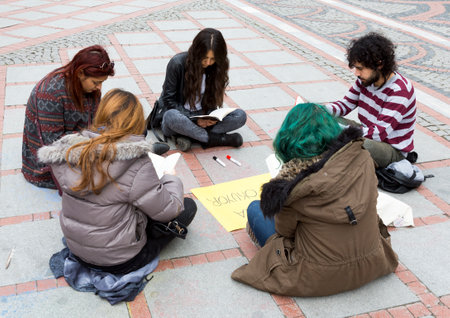 Istanbul, Turkey - November 16, 2014: Young people are reading books and painting on a street in Istanbul.のeditorial素材