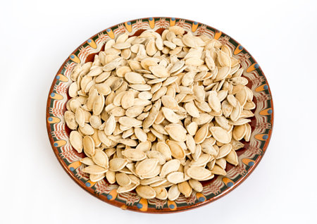 Unpeeled pumpkin seed in a traditional Bulgarian painted ceramic plate.