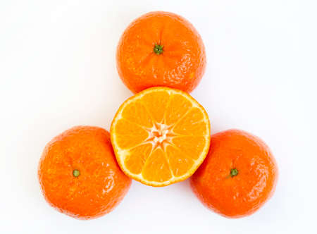 Three and a half mandarins isolated on a white background.の写真素材