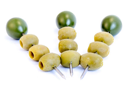 Green olives on a sticks isolated on a white background.の写真素材