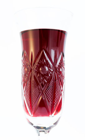 A crystal glass of red wine isolated on white.