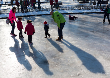Sofia, Bulgaria - January 11, 2015: A family is playing on the surface of a frozen fountain in a park in Sofia.のeditorial素材