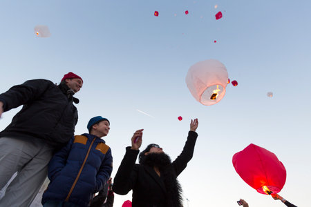 Sofia, Bulgaria - February 14, 2015: A family is releasing a floating lantern in the sky participating in an initiative at the Valentine's day.のeditorial素材