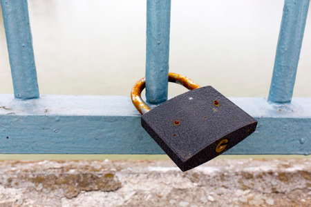 A lock on a fence colored in blue.の写真素材