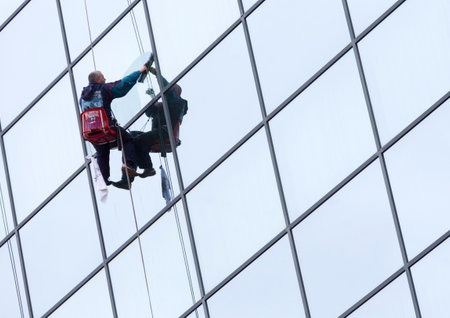 Sofia, Bulgaria - April 7, 2015: Sanitation worker are cleaning the glass facade of a hotel in the center of Sofia.のeditorial素材