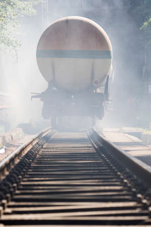 Gasoline tanker train is seen in smoke near Sofia, Bulgaria. Fire safety and civil protection service at Fire department is training in a situation of train crash with spilled toxic and flammable materials from the cargo tanks.の写真素材