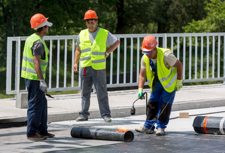 Sofia, Bulgaria - May 21, 2015: Construction workers are waterproofing a bridge surface floor at a highway in Sofia.のeditorial素材
