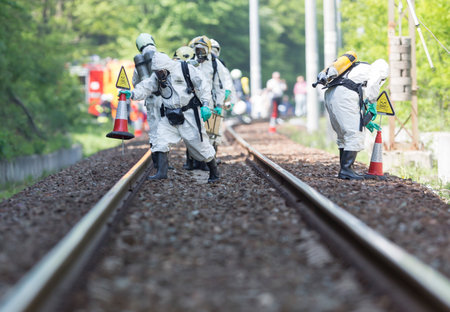 Sofia, Bulgaria - May 19, 2015: A team working with toxic acids and chemicals is approaching a chemical cargo train crash near Sofia. Teams from Fire department are participating in an emergency training with spilled toxic and flammable materials.のeditorial素材