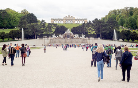 Vienna, Austria - May 1, 2015: Tourists are visiting the Neptune Fountain in the former imperial summer residence known as Schonbrunn Palace.のeditorial素材