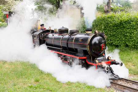 Vienna, Austria - May 2, 2015: Tourists and a train driver enjoy a ride on the so called Liliputbahn. A gauge light railway in the Prater Park.のeditorial素材