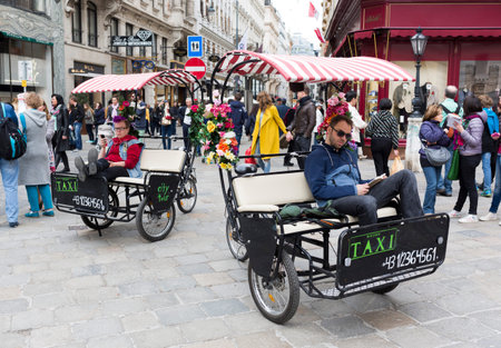 Vienna, Austria - May 1, 2015: Taxi drivers are waiting for tourists at the Michaelerplatz in...