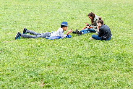 Vienna, Austria - May 1, 2015: Austrian teenagers are spending their free time on a grassy meadow in the center of Vienna, Austria.のeditorial素材