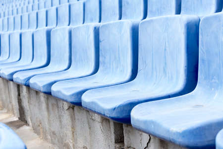 Many blue old seats at a stadium which need replacement.の写真素材
