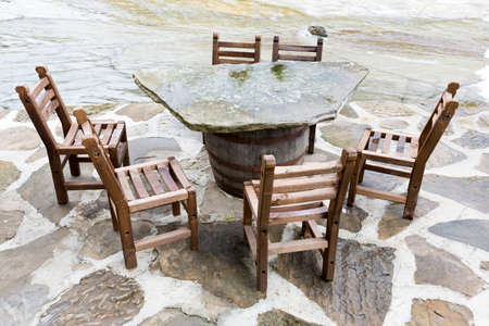 Authentic Bulgarian restaurant with wooden chairs and stone tables near the river.の写真素材