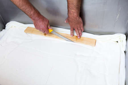 The process of producing tasty traditional white Bulgarian feta cheese at its final stage before packeting. Cutting cubes with a knife.の写真素材