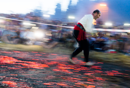 Rozhen, Bulgaria - July 18, 2015: A nestinar is walking on fire during a nestinarstvo show. The fire ritual involves a barefoot dance on smouldering embers performed by nestinari.のeditorial素材