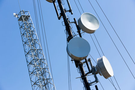 Telecommunications tower against the blue sky. Antennas for television, radio, and mobile phones.