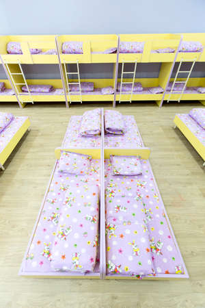 Modern kindergarten bedroom with small bunk beds with stairs for the kids.の写真素材