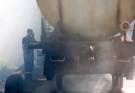 Sofia, Bulgaria - May 19, 2015: Oil tanker train is seen in smoke near Sofia. Fire safety and civil protection service at Fire department is training in a situation of train crash with spilled toxic and flammable materials from the cargo tanks.のeditorial素材