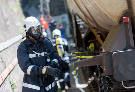 Sofia, Bulgaria - May 19, 2015: Firefighters are extinguishing chemical cargo train tanks near Sofia. Teams from Fire department are participating in an emergency training with spilled toxic and flammable materials.のeditorial素材
