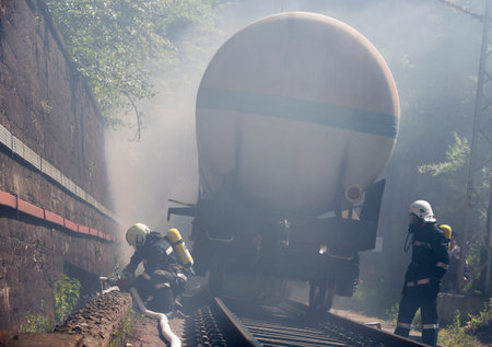 Sofia, Bulgaria - May 19, 2015: Firefighters are extinguishing chemical cargo train tanks near...