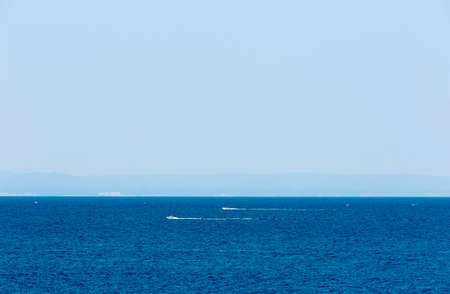 Two small boats are sailing in the blue water on the Black sea.の写真素材
