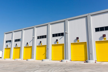 Seven yellow garage doors of a warehouse.の写真素材