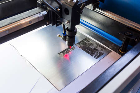 Laser machine is cutting an image on a flat sheet ot steel in a university laboratory.の写真素材