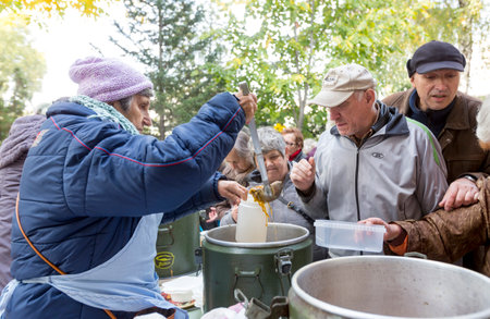 Sofia, Bulgaria - October 26, 2015: Church personnel is giving food to the christian believers who have come to the morning prayer.のeditorial素材