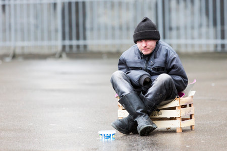 Saint Petersburg, Russia - November 20, 2015: Young man is begging for money in front of a church in Saint Petersburg, Russia.のeditorial素材