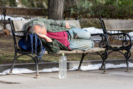 A homeless man is sleeping on a bench in a park in Bulgaria's capital Sofia. Years after joining the...