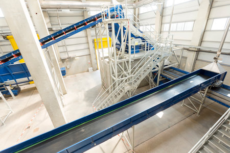 Inside of a waste management facility. Treatment and disposal of waste. Prevention of waste production through in-process modification, reuse and recycling. Convert waste materials into new products.のeditorial素材