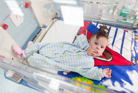 Sofia, Bulgaria - March 1, 2016: A baby with a cardiac disease is seen from above in an incubator in a cardilogical children's hospital. High-quality treatment with modern equipment.のeditorial素材