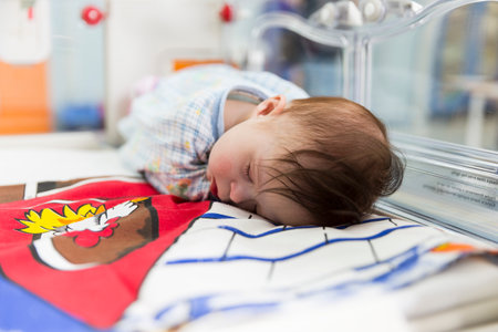 Sofia, Bulgaria - March 1, 2016: A baby with a cardiac disease is sleeping in an incubator in a cardilogical children's hospital. High-quality treatment with modern equipment.のeditorial素材