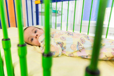 Sofia, Bulgaria - March 1, 2016: An young baby boy with a cardiac disease is lying in a bed in a cardilogical children's hospital. High-quality treatment with modern equipment.のeditorial素材