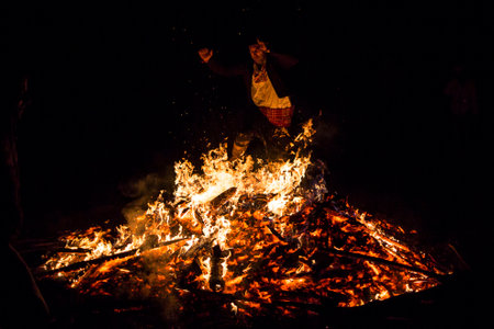 Sofia, Bulgaria - March 13, 2016: An young man is participating in a fire ritual during a celebration of Sirni Zagovezni. It is believed that evil spirits are chased away with this fire rituals.のeditorial素材